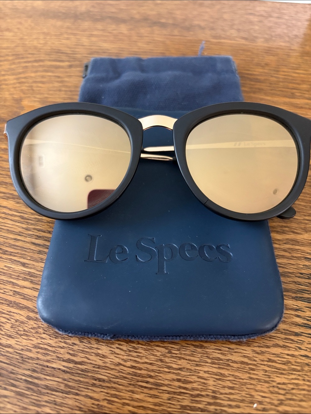 Le Specs Round Sunglasses in Matte Black with Gold Bridge and Gold Lenses